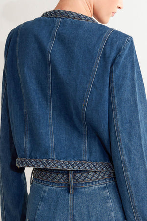 A washed denim jacket featuring round neckline, braided trim and hook &amp; eye closure