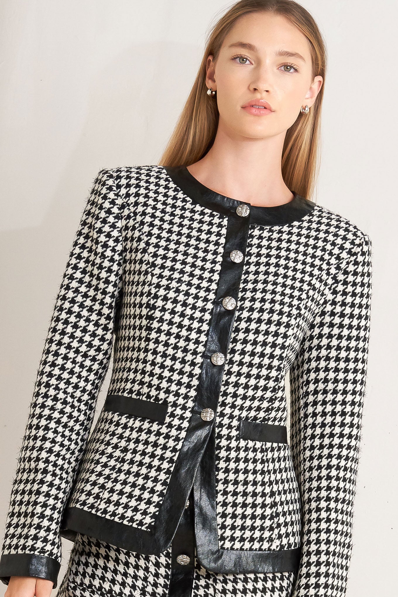 A tweed jacket featuring round collar, front button down, long sleeve and faux leather edge