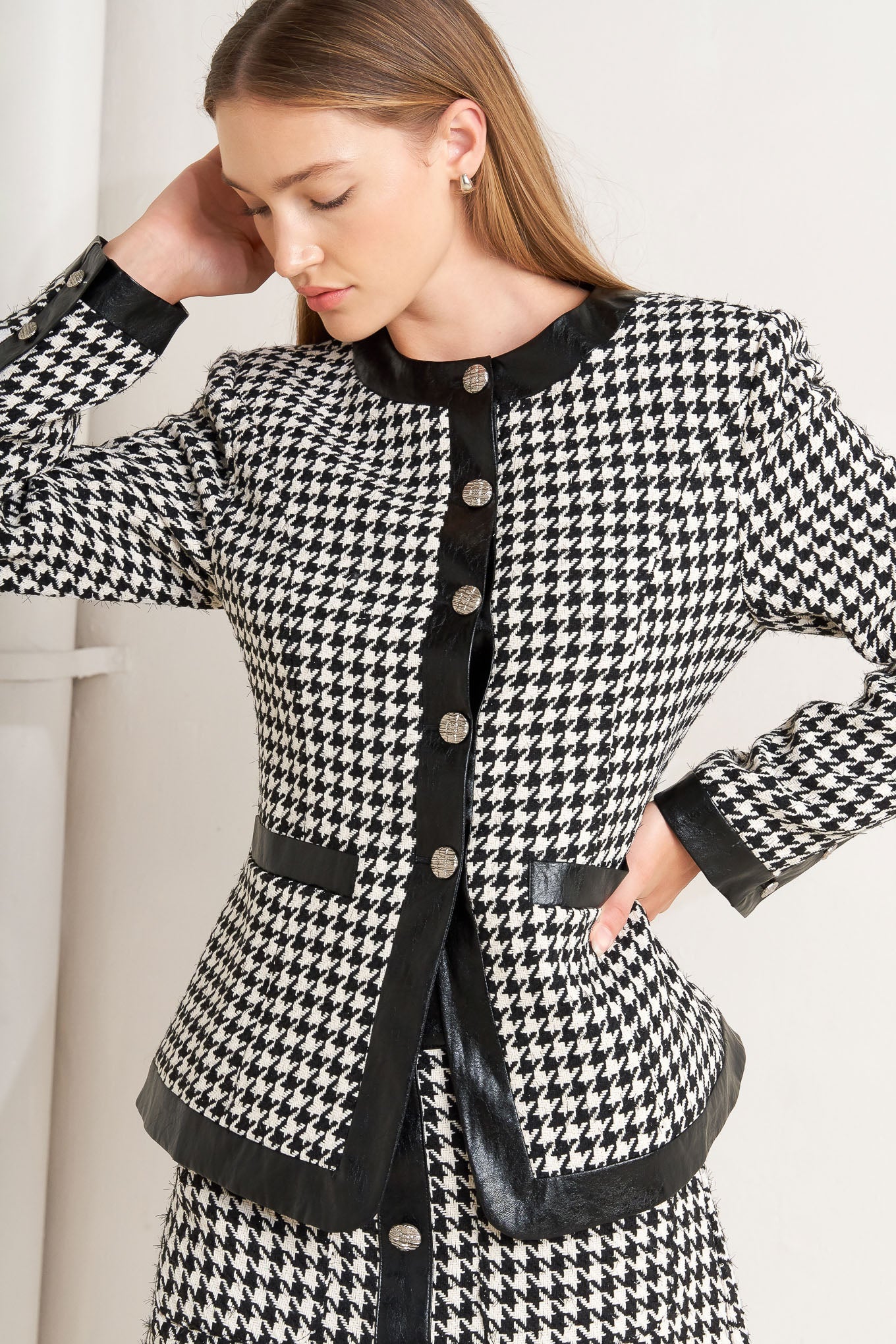 A tweed jacket featuring round collar, front button down, long sleeve and faux leather edge