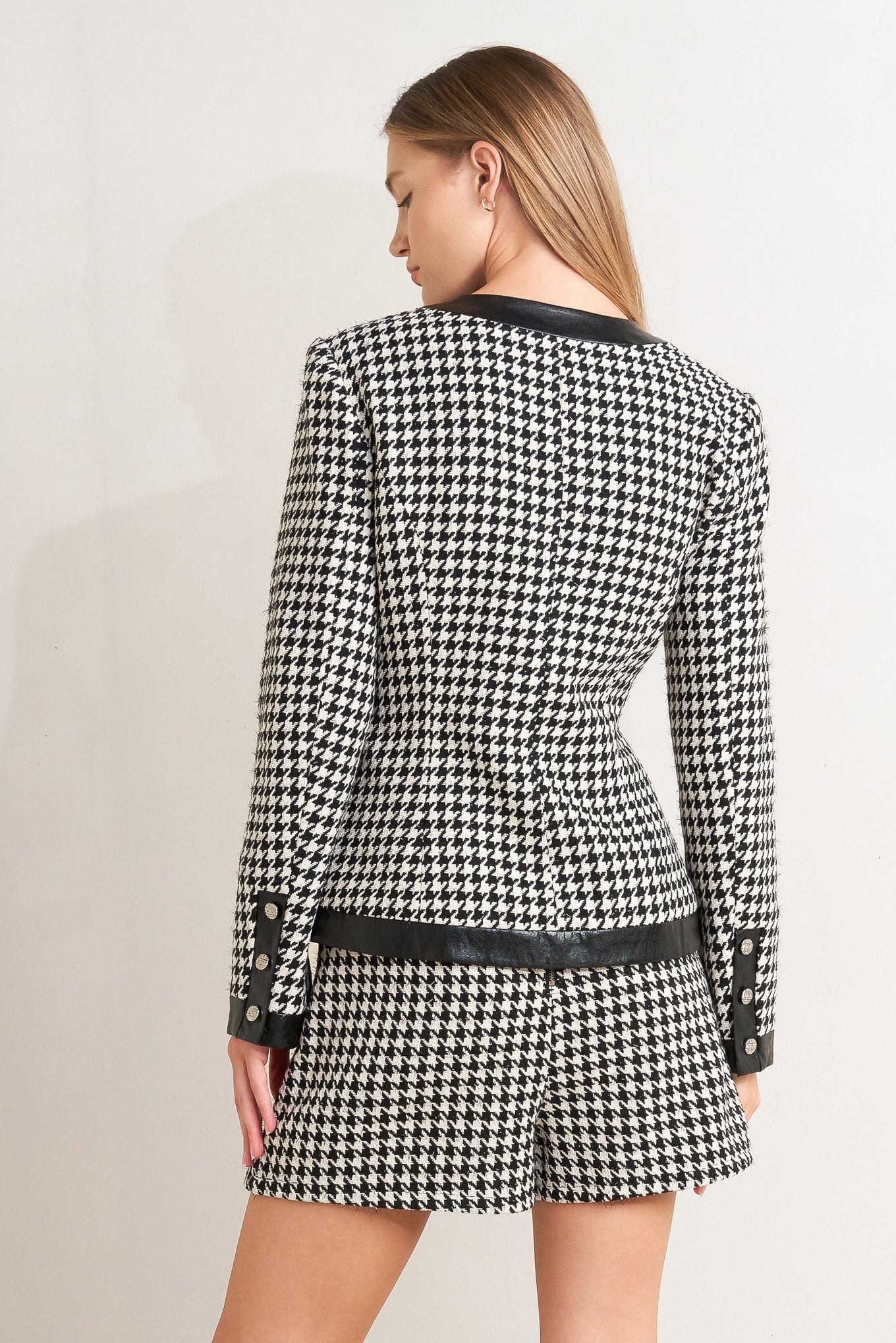 A tweed jacket featuring round collar, front button down, long sleeve and faux leather edge