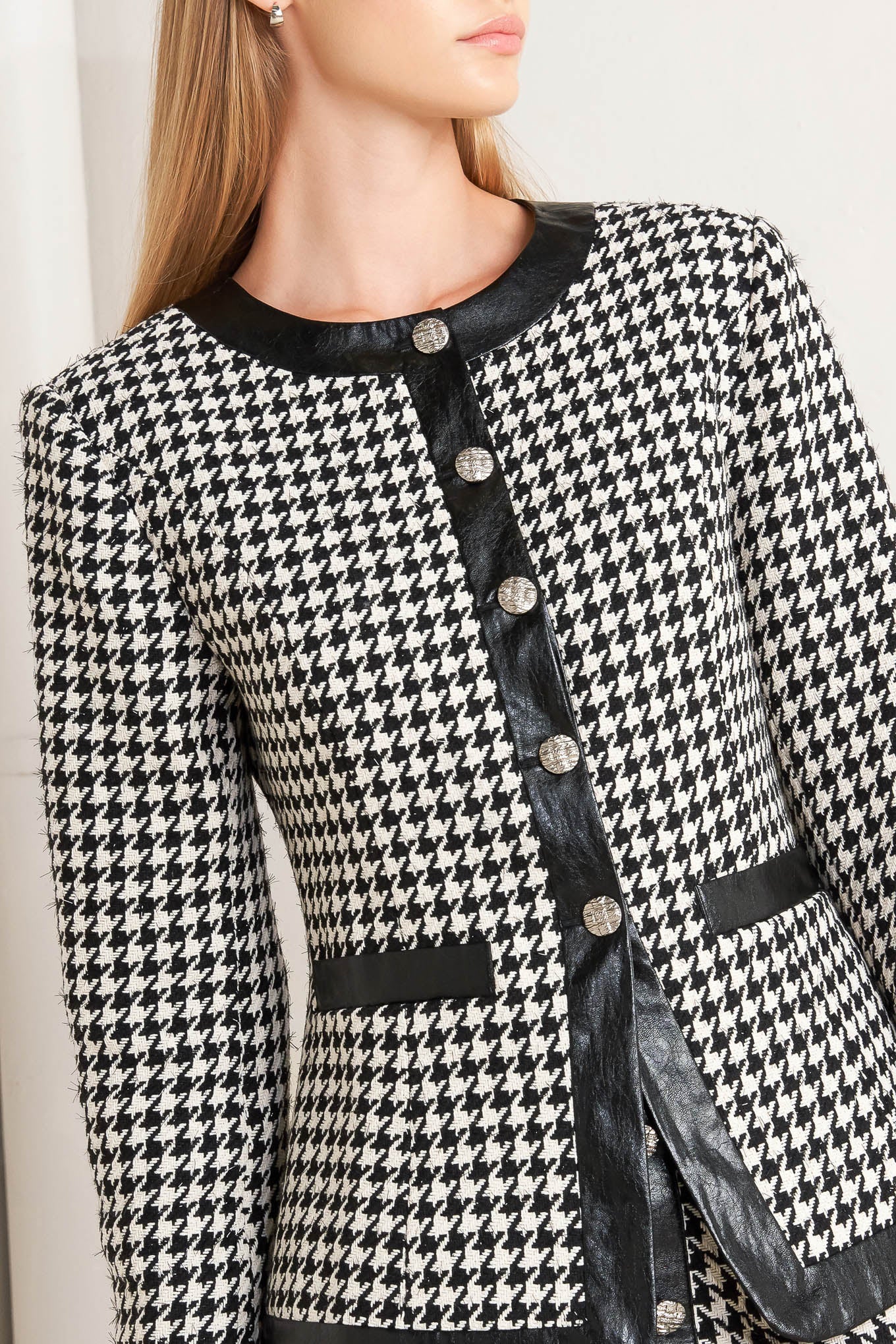 A tweed jacket featuring round collar, front button down, long sleeve and faux leather edge