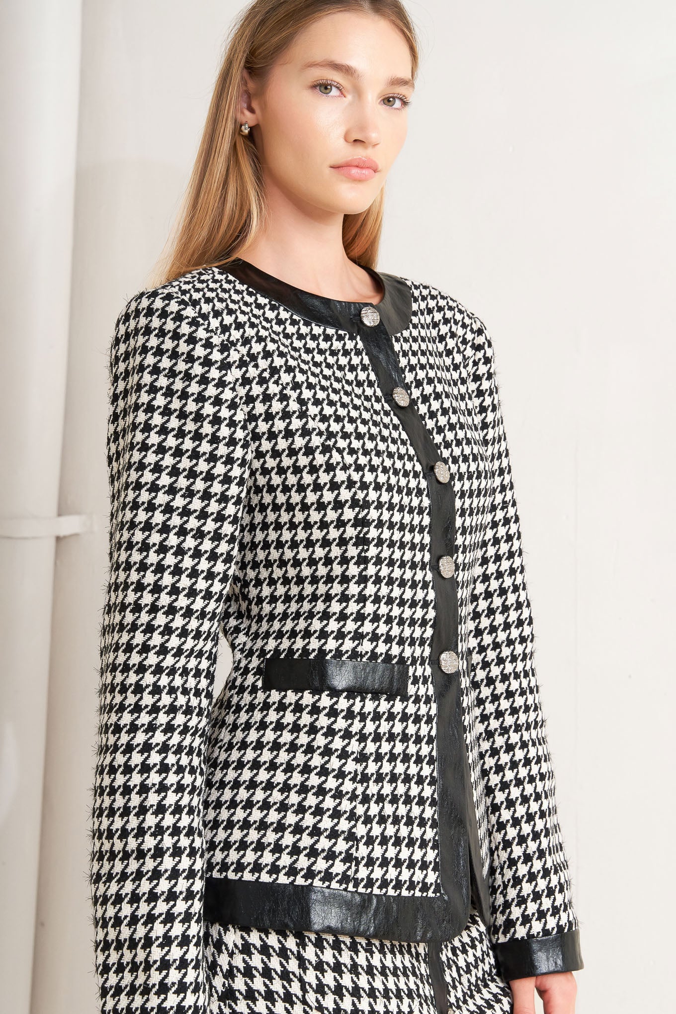 A tweed jacket featuring round collar, front button down, long sleeve and faux leather edge
