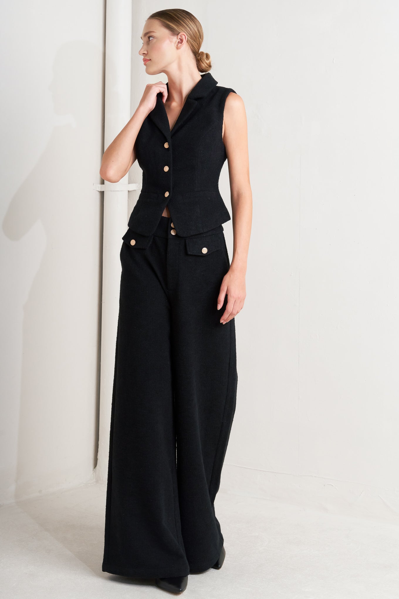 A woven vest featuring collar, sleeveless and front button closure.