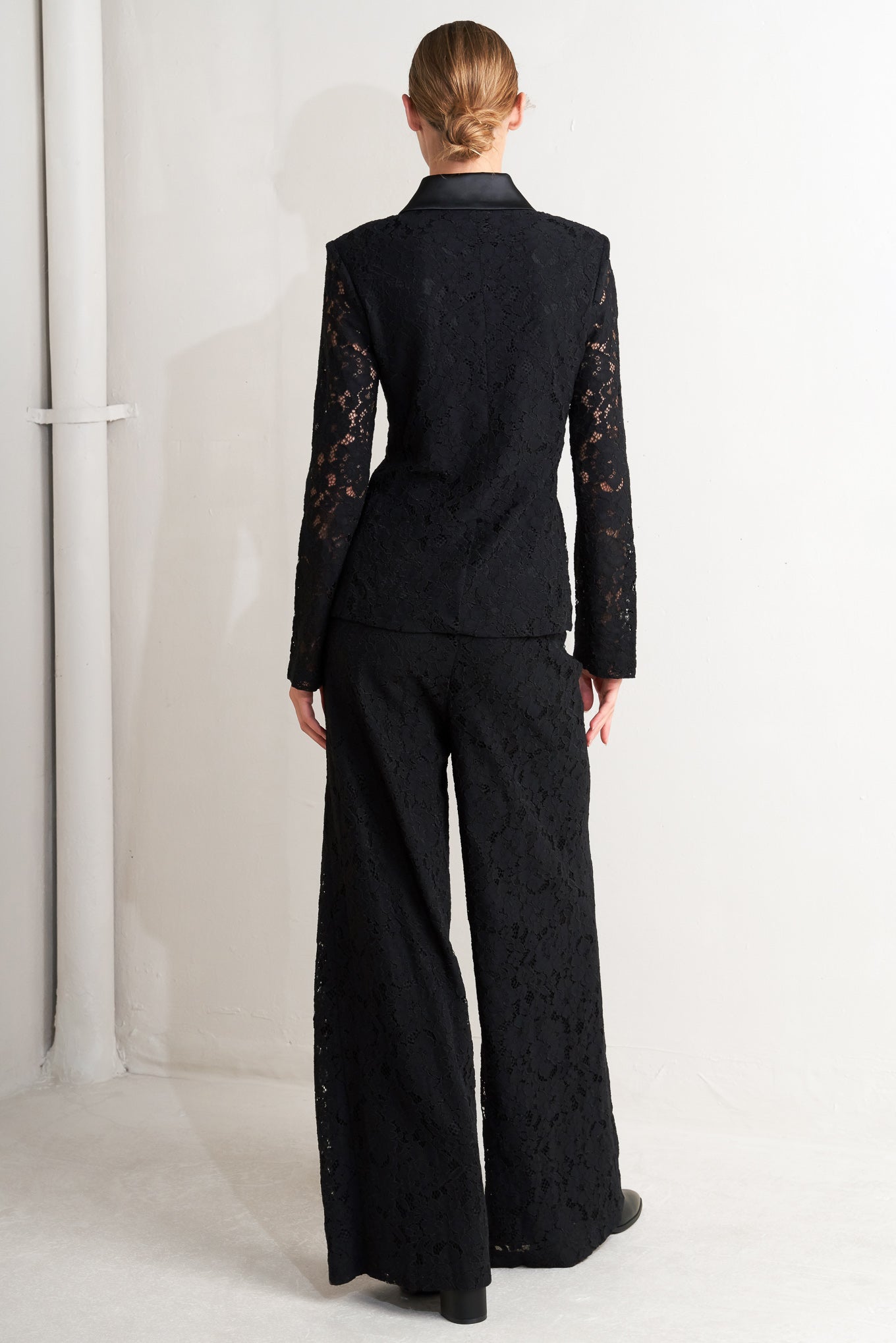 A woven lace blazer with contrasting collar, long sleeve and single button closure.