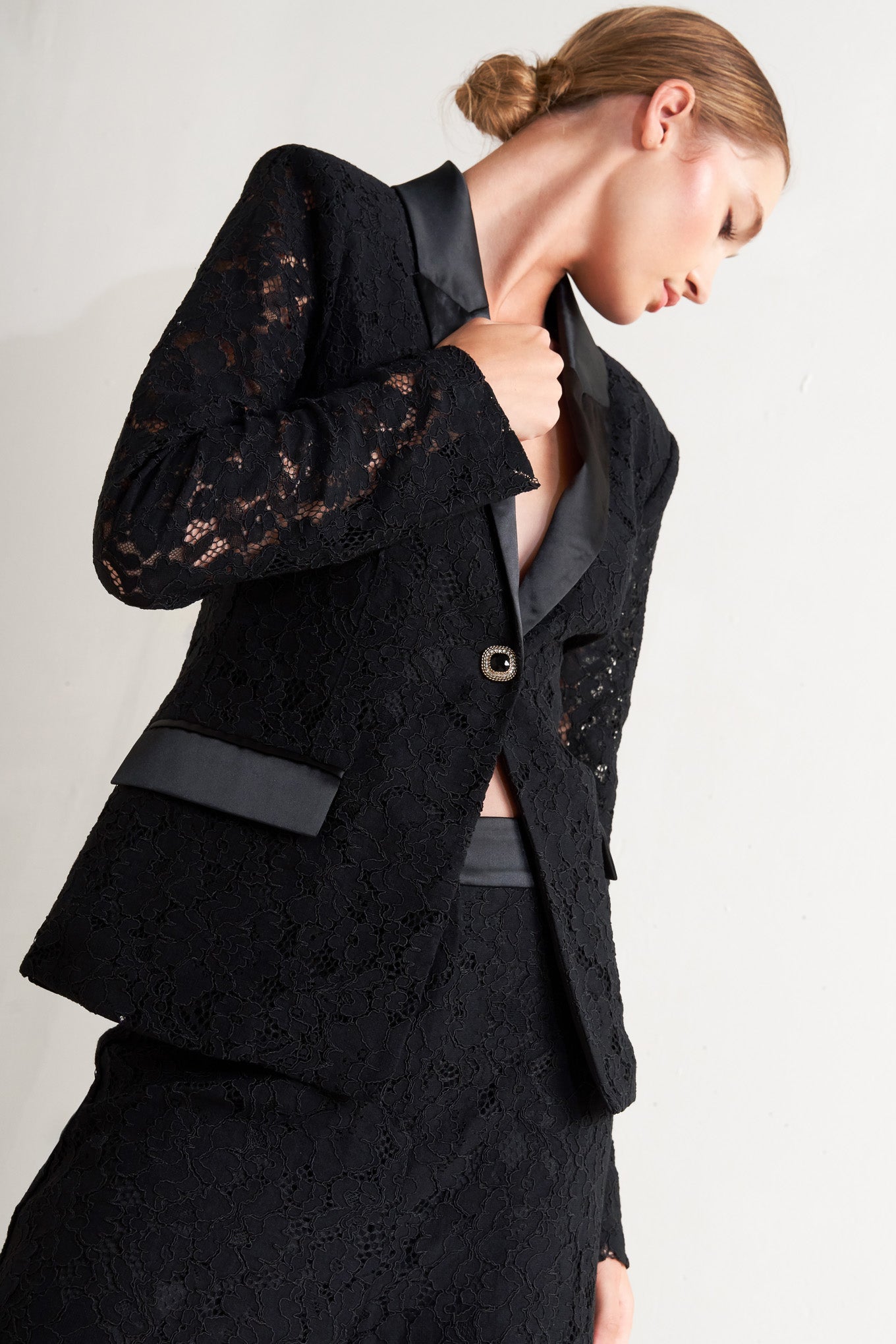 A woven lace blazer with contrasting collar, long sleeve and single button closure.