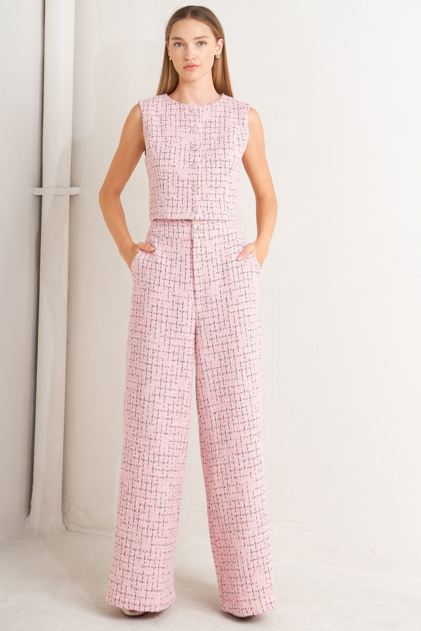 A tweed vest featuring round neckline, sleeveless and front button down.