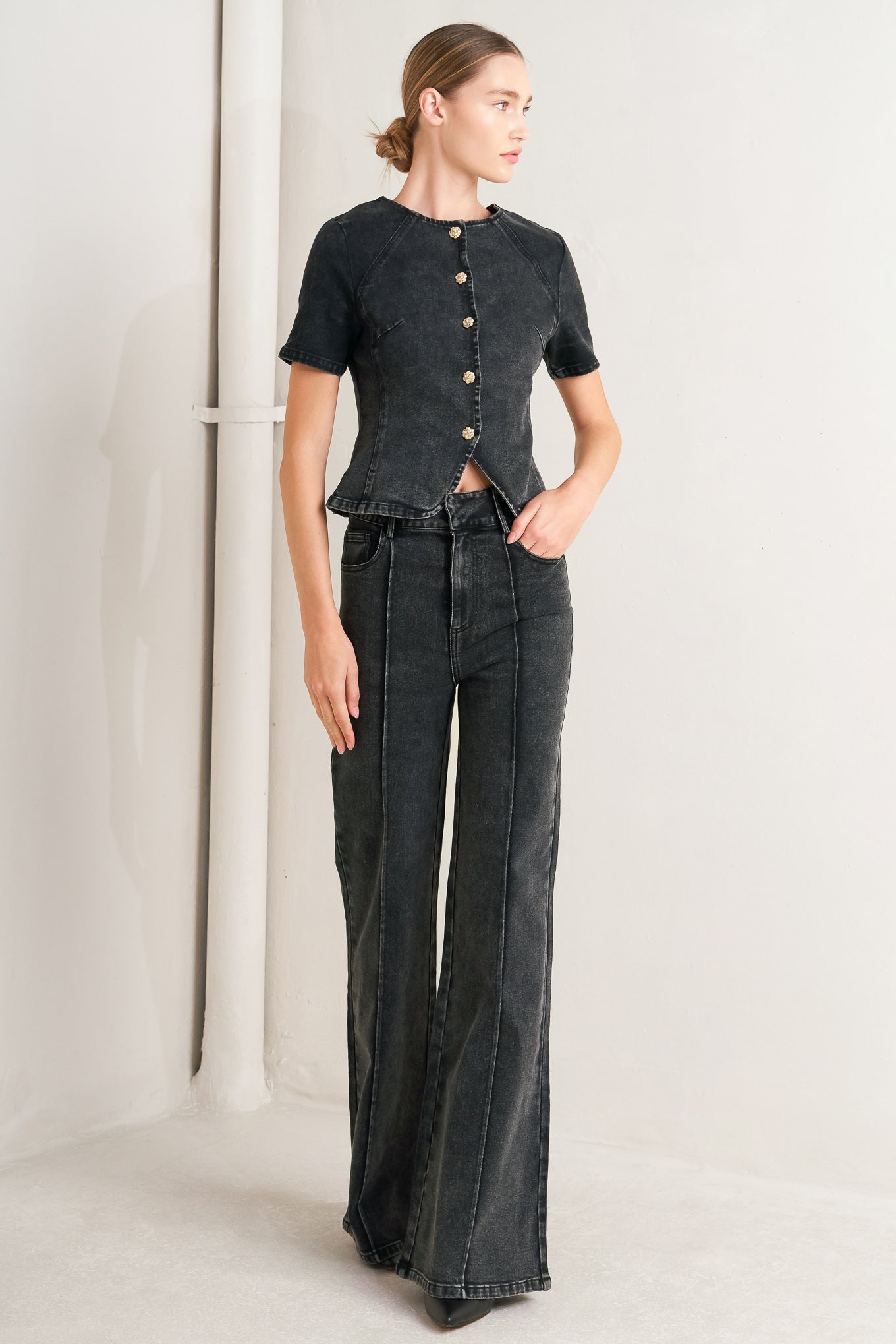 A washed denim jacket featuring round neckline, short sleeve and front button down closure. 