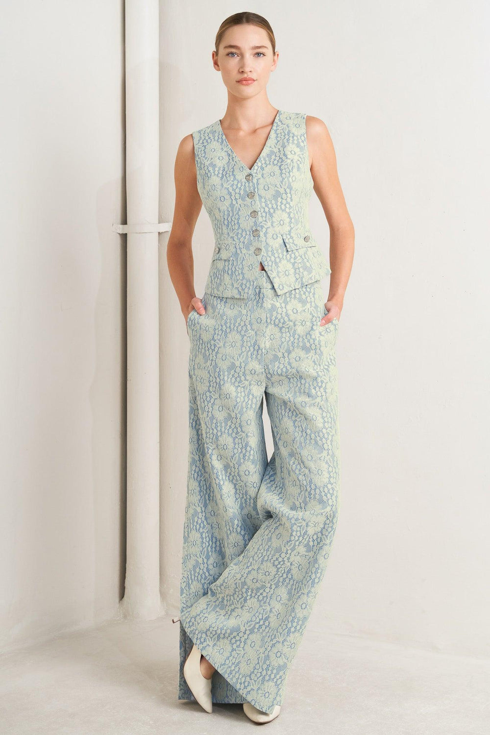 A woven bonded lace vest featuring V neckline, sleeveless and button down

Details:

Self: 50% Rayon 50% Polyester

Size & Fit

-Model is 5`8" And Wearing Size Small
-Measurements Taken From Size Small
-Approx. Length: 22"