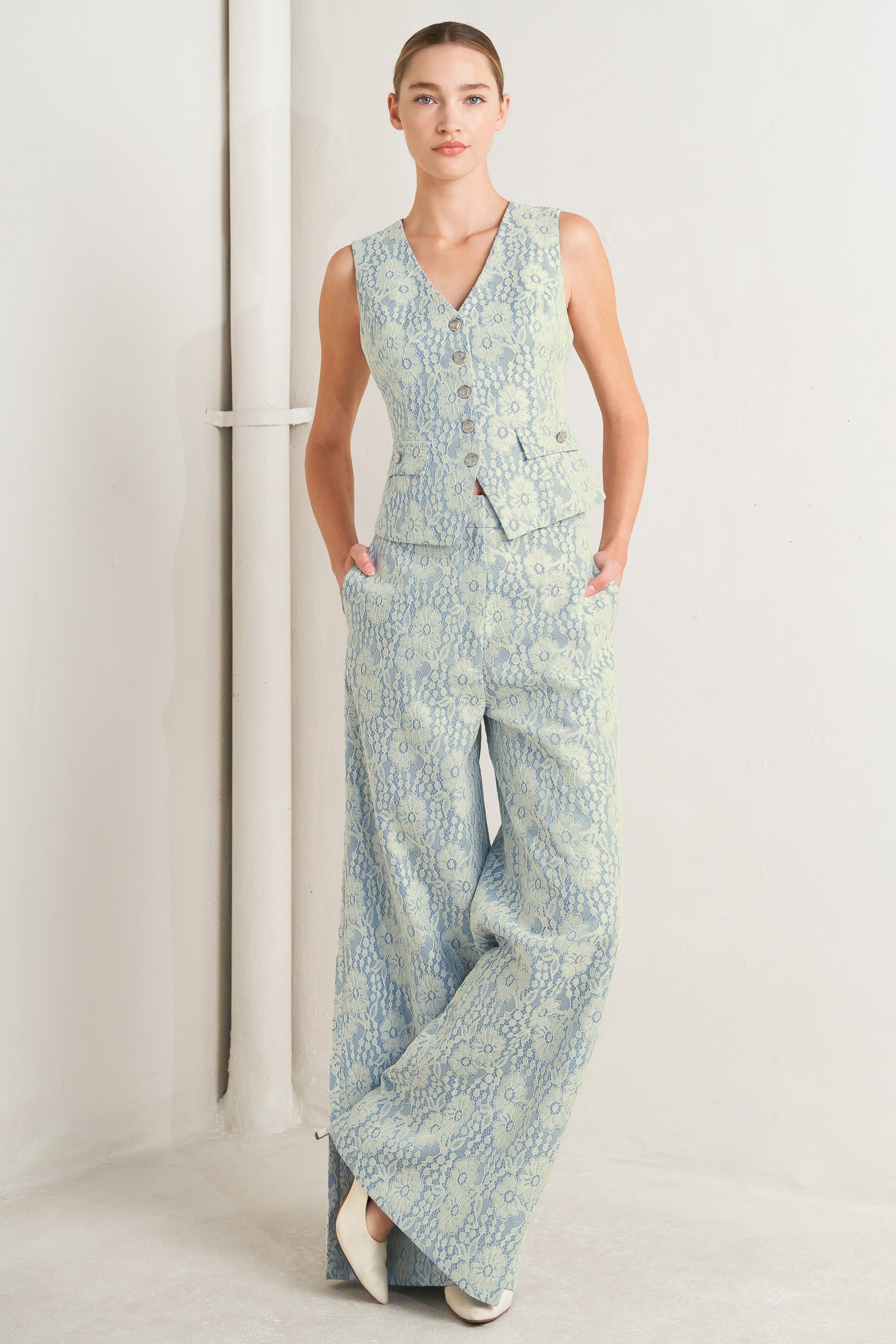 A woven bonded lace vest featuring V neckline, sleeveless and button down

Details:

Self: 50% Rayon 50% Polyester

Size & Fit

-Model is 5`8" And Wearing Size Small
-Measurements Taken From Size Small
-Approx. Length: 22"