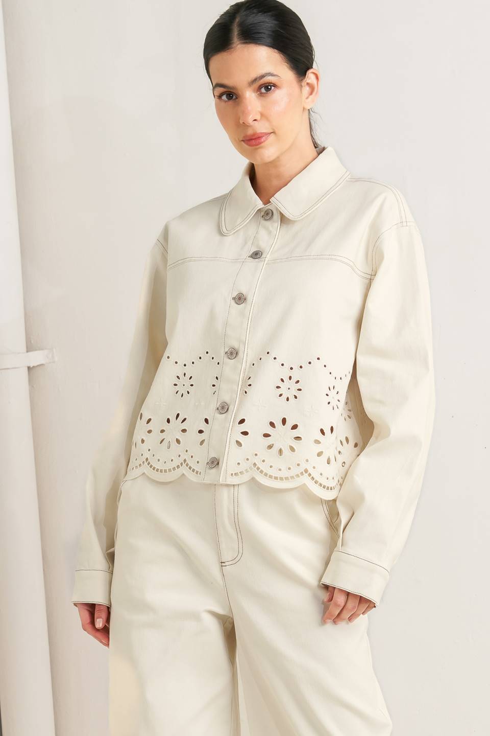 Woman wearing a cream-colored jacket with intricate cut-out design on a white background - SET - FLYING TOMATO