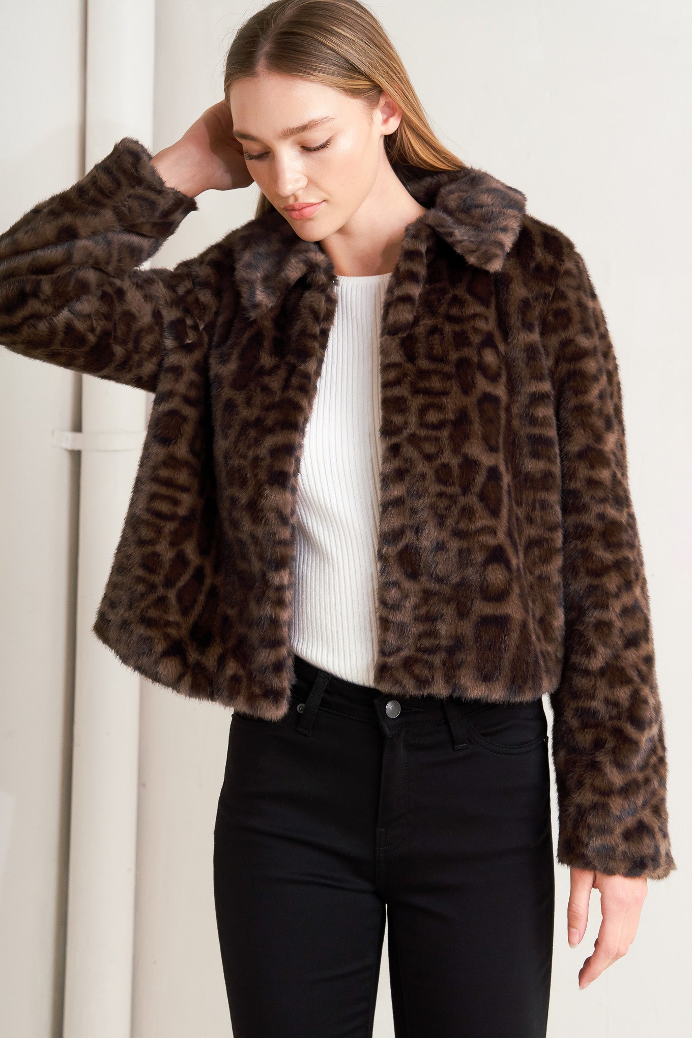 A leopard faux leather jacket with front closure and long sleeve