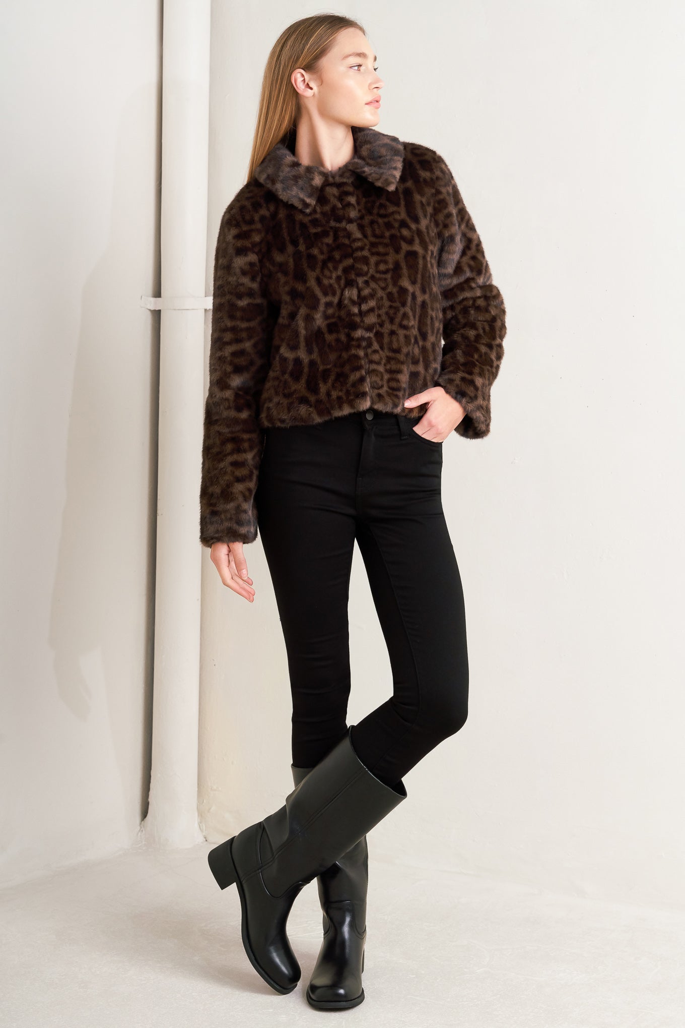 A leopard faux leather jacket with front closure and long sleeve