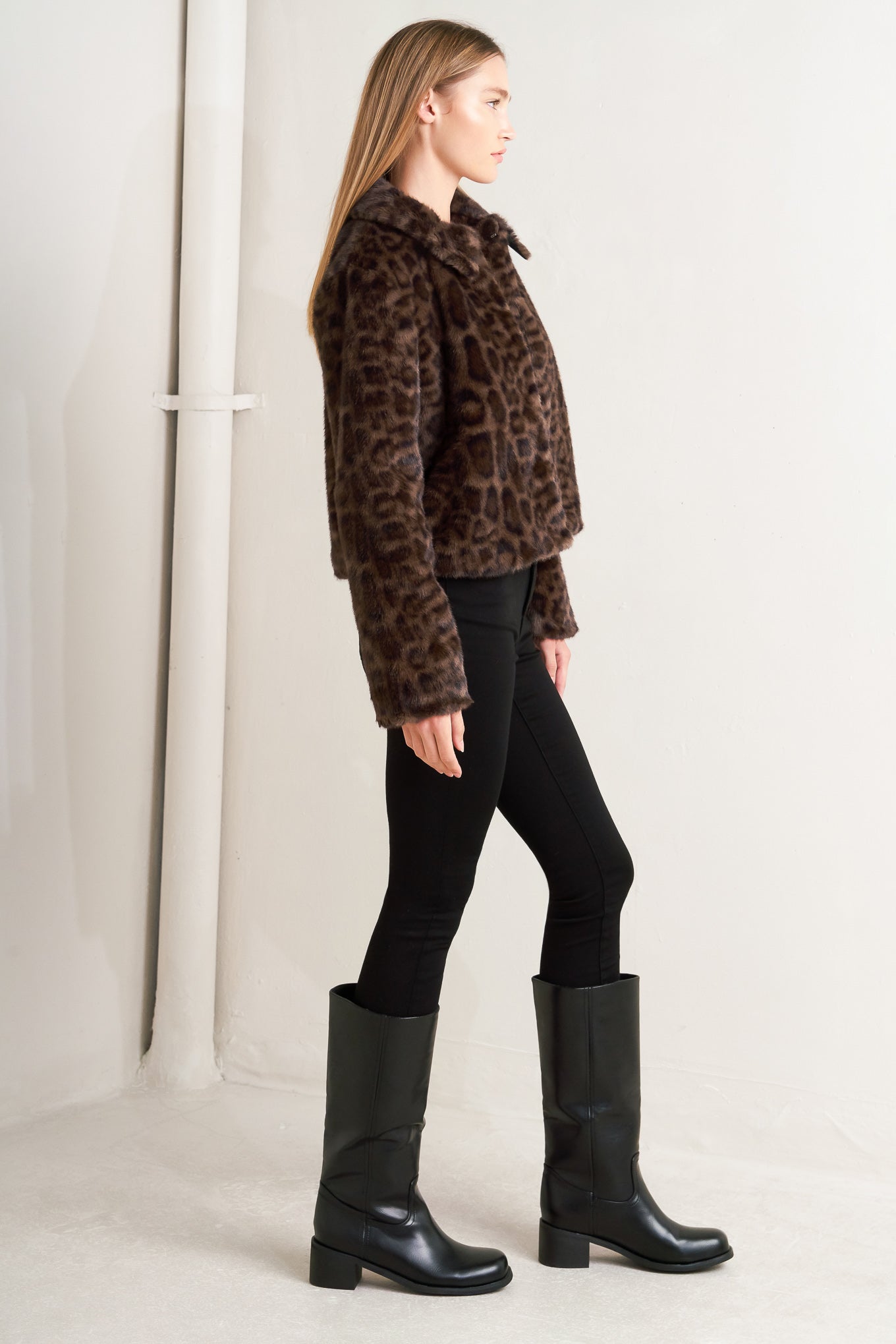 A leopard faux leather jacket with front closure and long sleeve