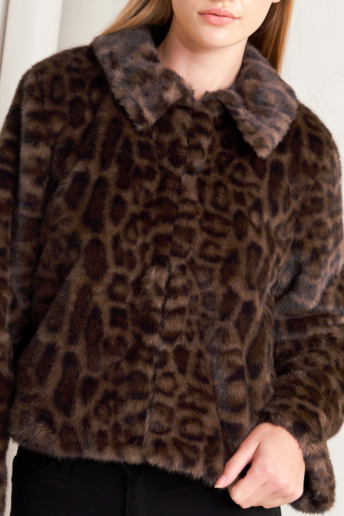 A leopard faux leather jacket with front closure and long sleeve