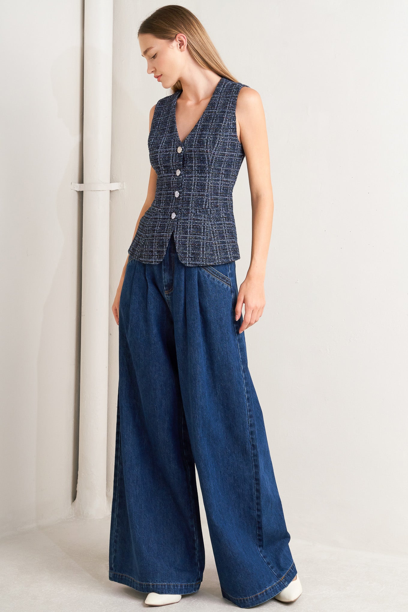 A tweed vest with front button closure