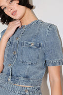 
A washed denim jacket featuring round neckline, short sleeve, front pockets and front button down. Matching skort FP2018T

Details:

Self : 100% Cotton

Size &amp; Fit

- Model is 5`8" And Wearing Size Small
- Measurements Taken From Size Small
- Approx. Length: 19"