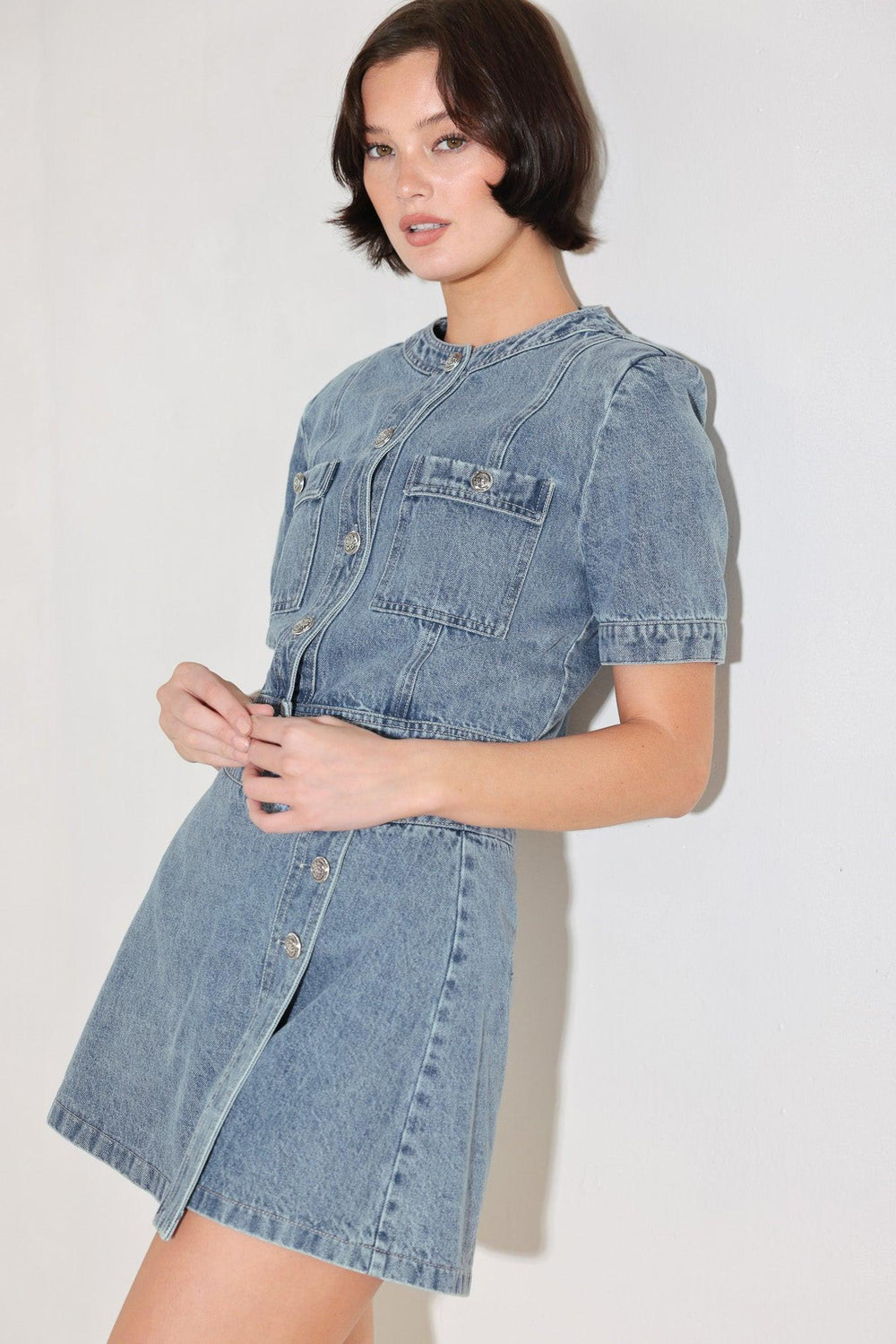 
A washed denim jacket featuring round neckline, short sleeve, front pockets and front button down. Matching skort FP2018T

Details:

Self : 100% Cotton

Size &amp; Fit

- Model is 5`8" And Wearing Size Small
- Measurements Taken From Size Small
- Approx. Length: 19"
