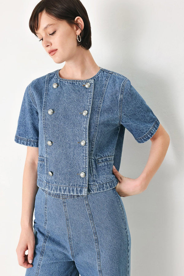 A washed denim jacket featuring round neckline, elbow sleeve, double button down and side pocket.