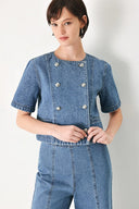 A washed denim jacket featuring round neckline, elbow sleeve, double button down and side pocket.