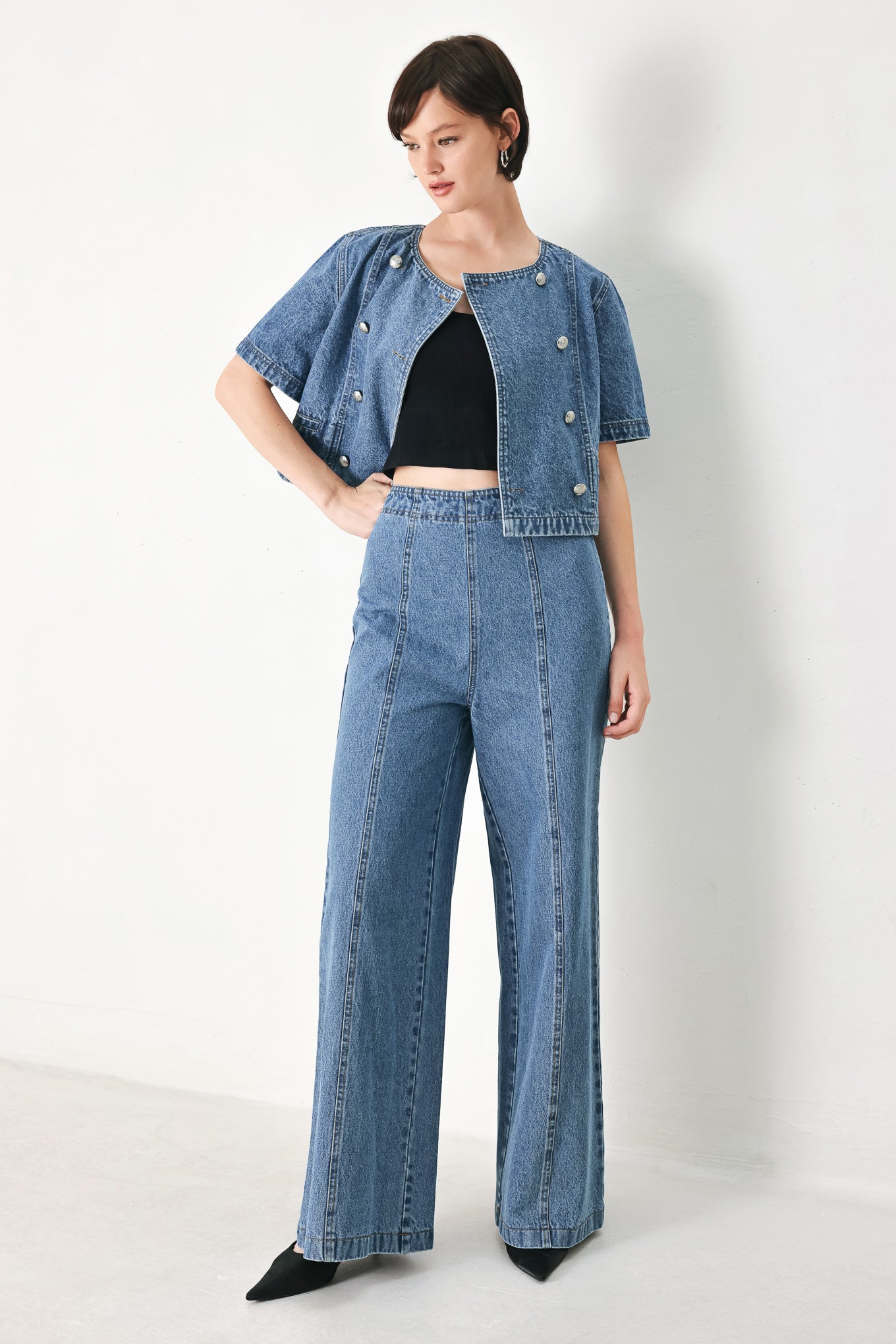 A washed denim jacket featuring round neckline, elbow sleeve, double button down and side pocket.