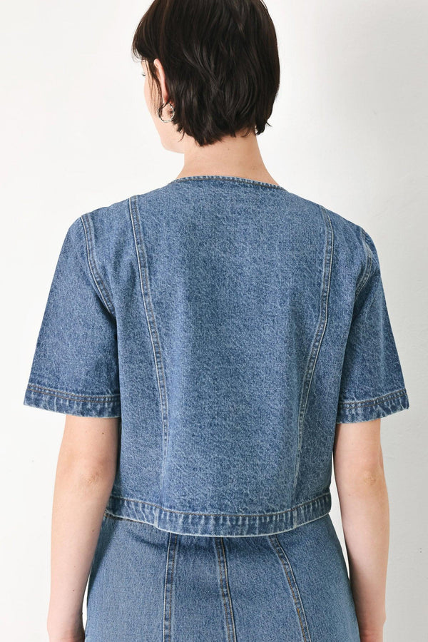 A washed denim jacket featuring round neckline, elbow sleeve, double button down and side pocket.