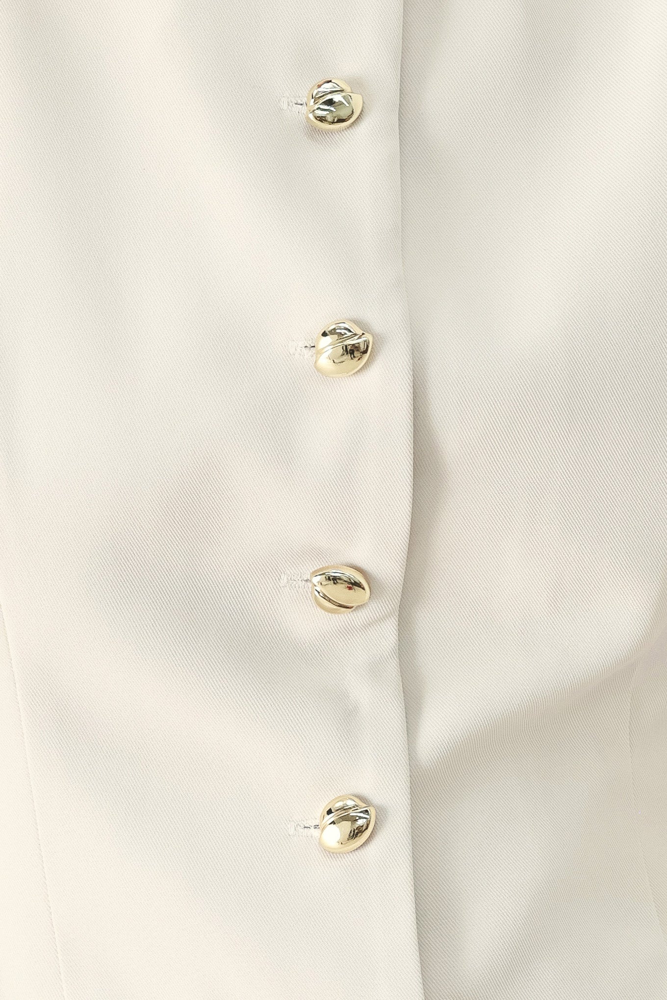 Close up of an ivory woven vest with wide neckline, sleeveless and front button down| FREEMARKET