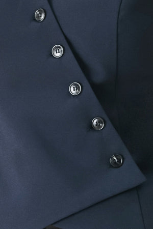 Woman wearing a navy blue sleeveless vest with asymmetrical overlap and buttons | FREEMARKET