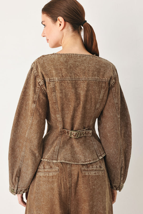 Woman wearing a washed brown denim jacket with round neckline and front button down | FREEMARKET