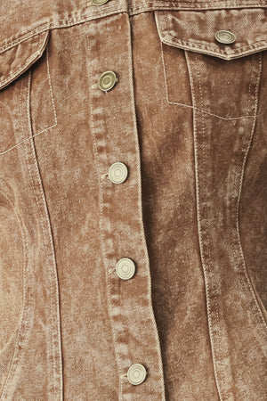 Woman wearing a washed brown denim jacket with round neckline and front button down | FREEMARKET