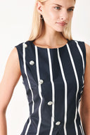 Woman wearing a navy blue top with white stripes and silver buttons featuring round neckline, sleeveless, diagonal button detail and back zipper closure | FREEMARKET