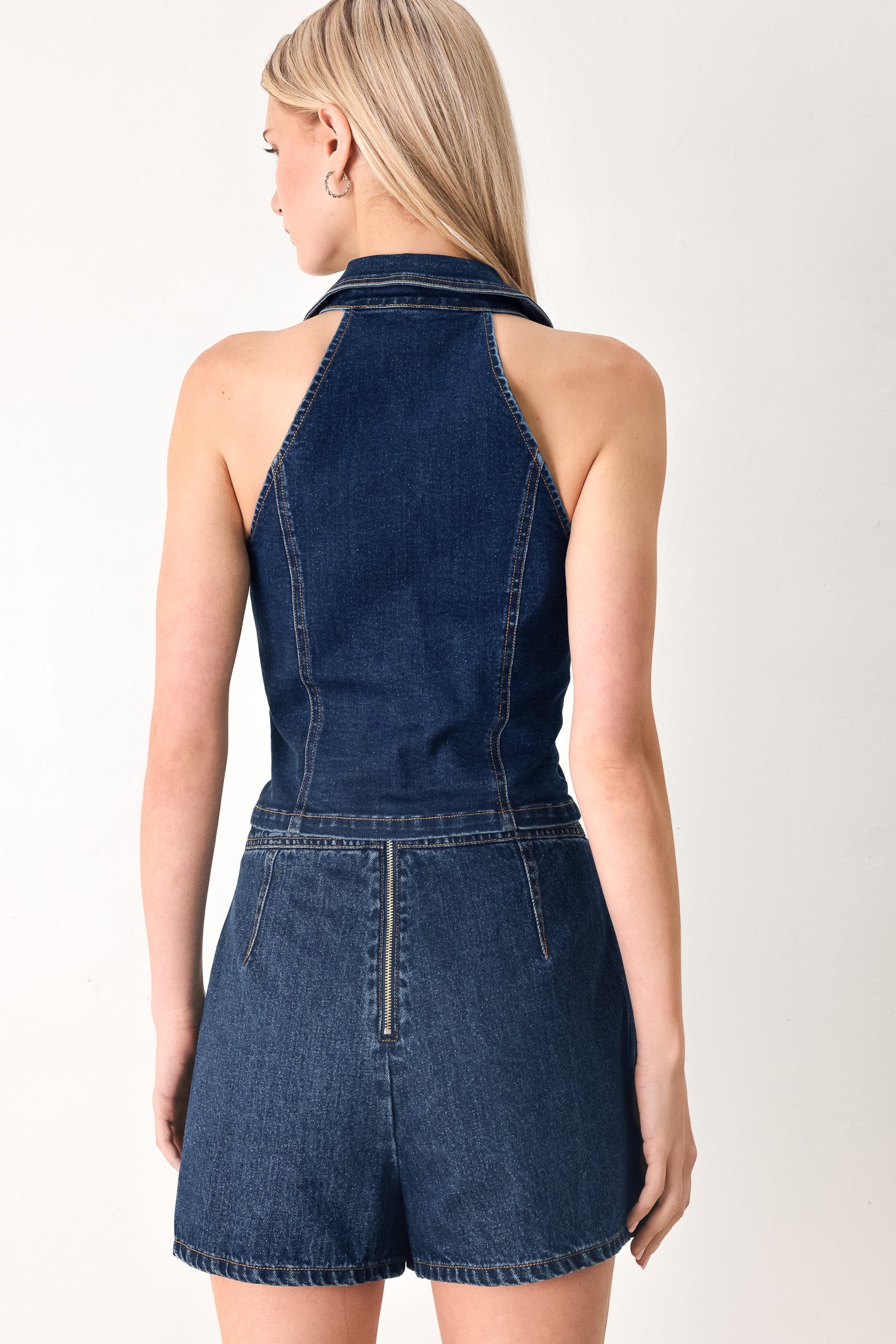 Woman wearing a denim vest with collar and front button closure | FREEMARKET