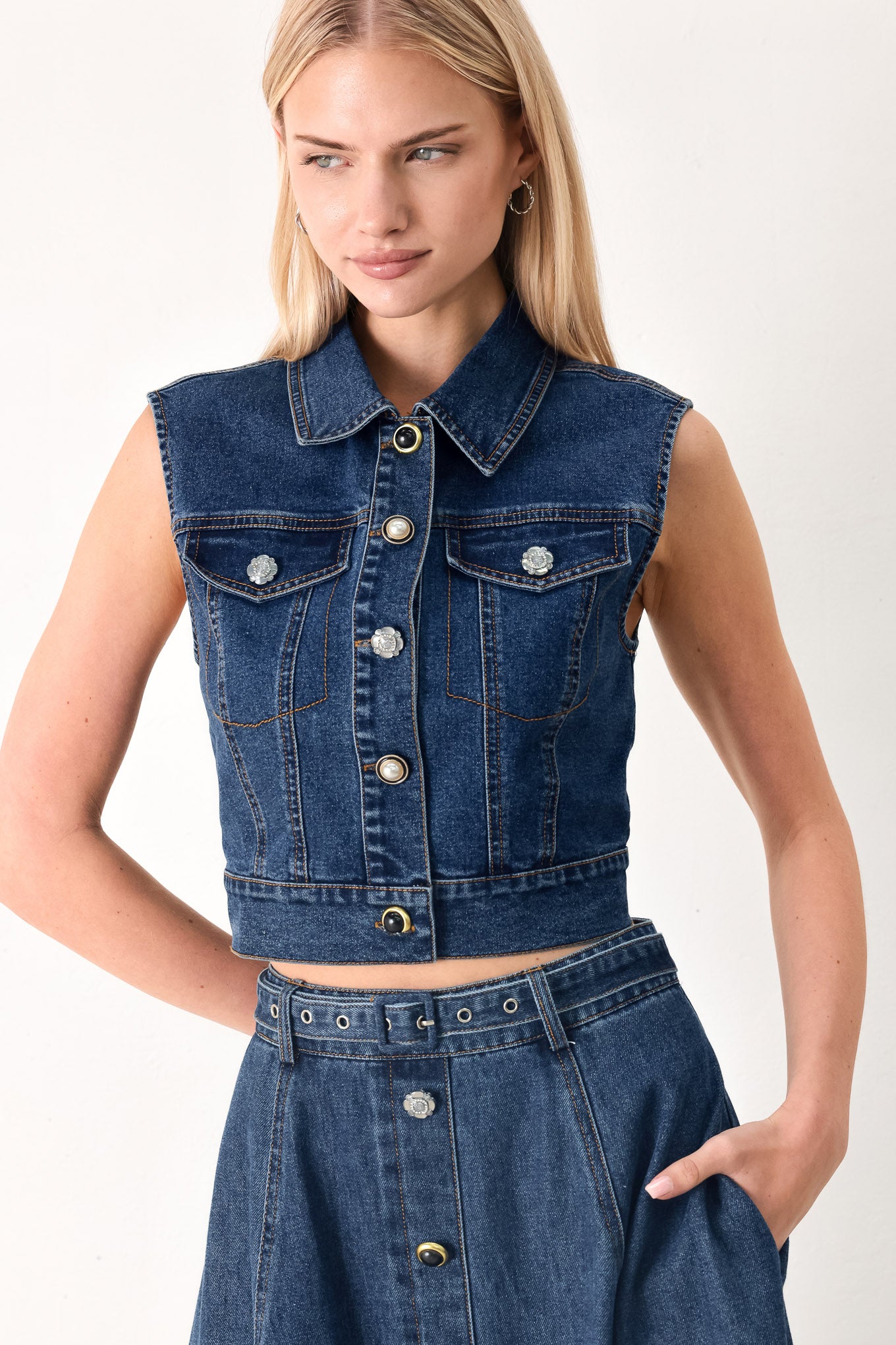 Woman wearing a blue denim cropped vest with front button down and sleeveless | FREEMARKET