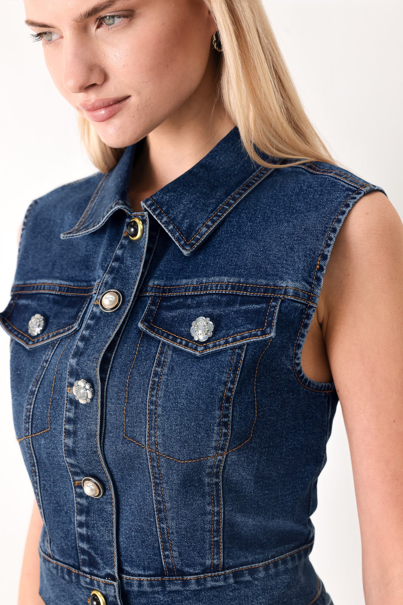 Woman wearing a blue denim cropped vest with front button down and sleeveless | FREEMARKET