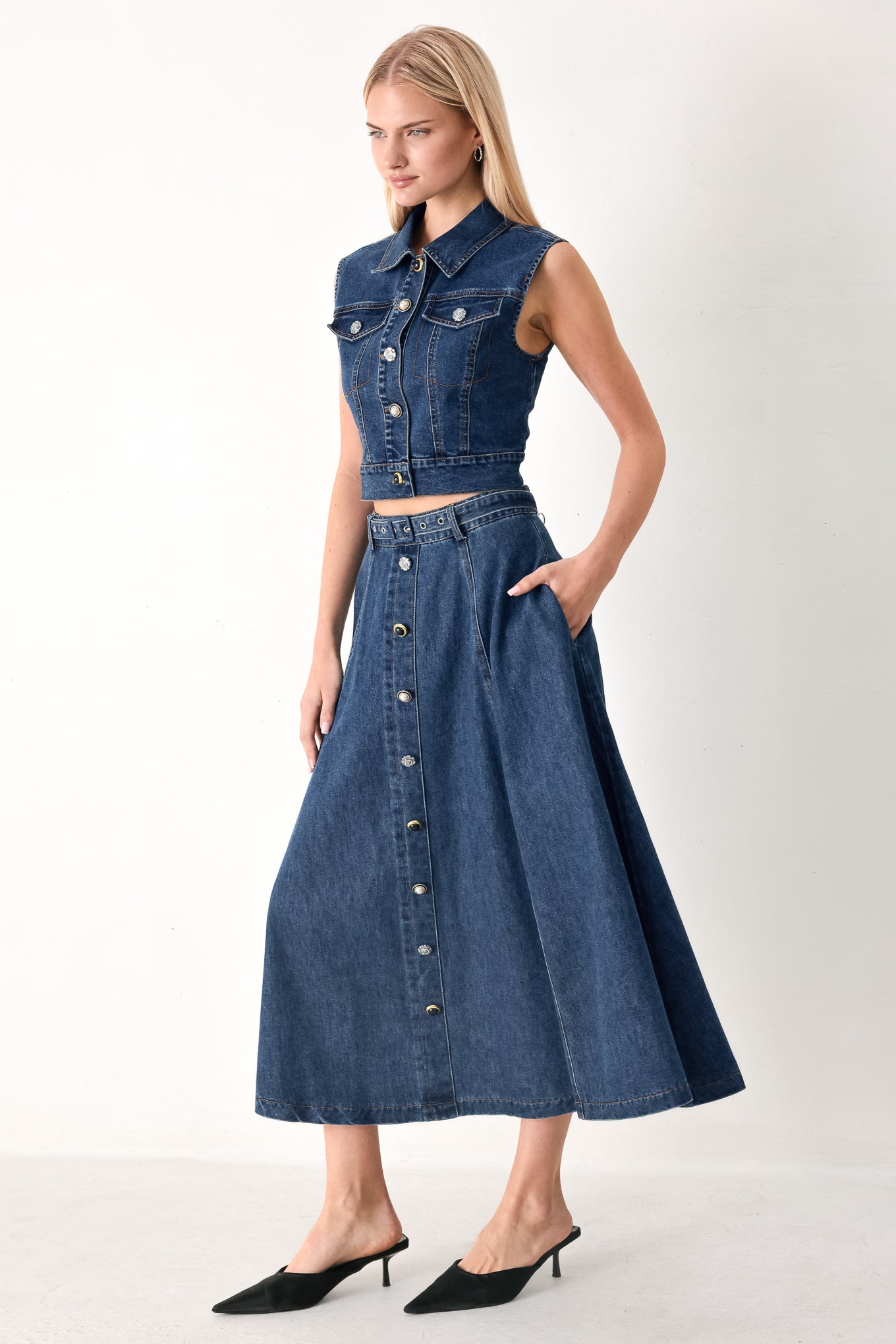 Woman wearing a blue denim cropped vest with front button down and sleeveless | FREEMARKET