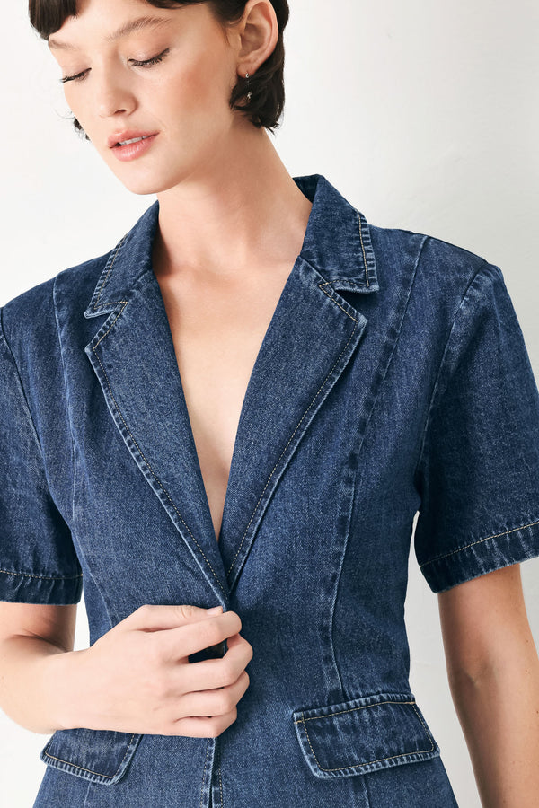 Woman wearing a short sleeve washed denim jacket featuring collar, deep v-cut with a single front button closure | FREEMARKET