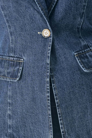 Woman wearing a short sleeve washed denim jacket featuring collar, deep v-cut with a single front button closure | FREEMARKET