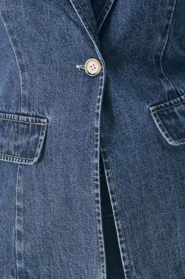 Woman wearing a short sleeve washed denim jacket featuring collar, deep v-cut with a single front button closure | FREEMARKET