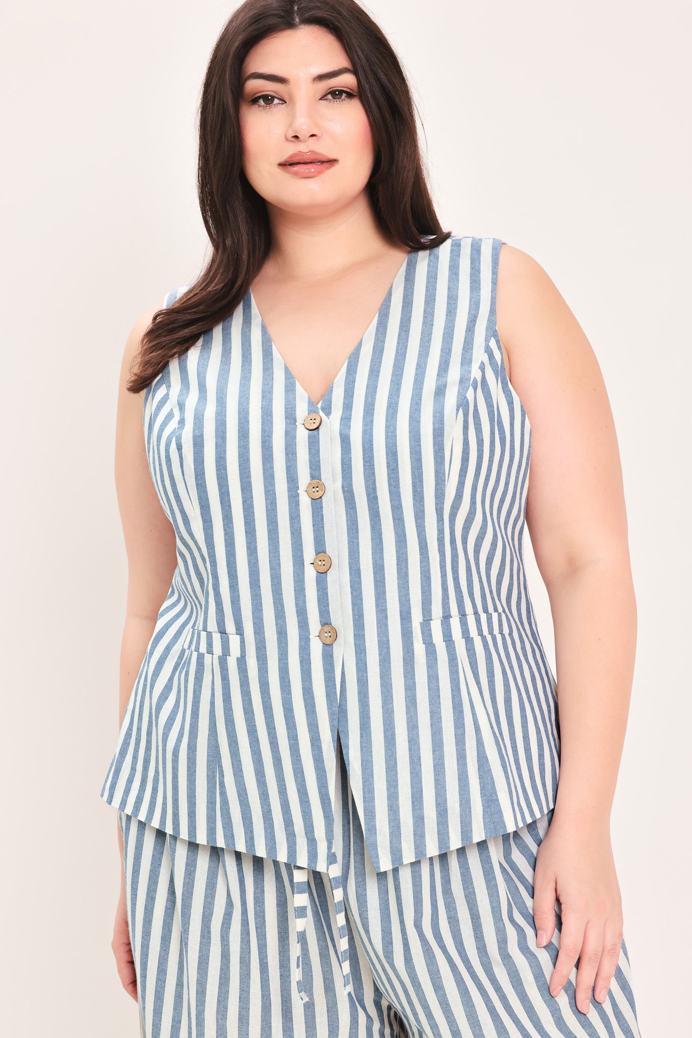 Woman wearing a a striped woven vest with front closure and sleeveless | FREEMARKET