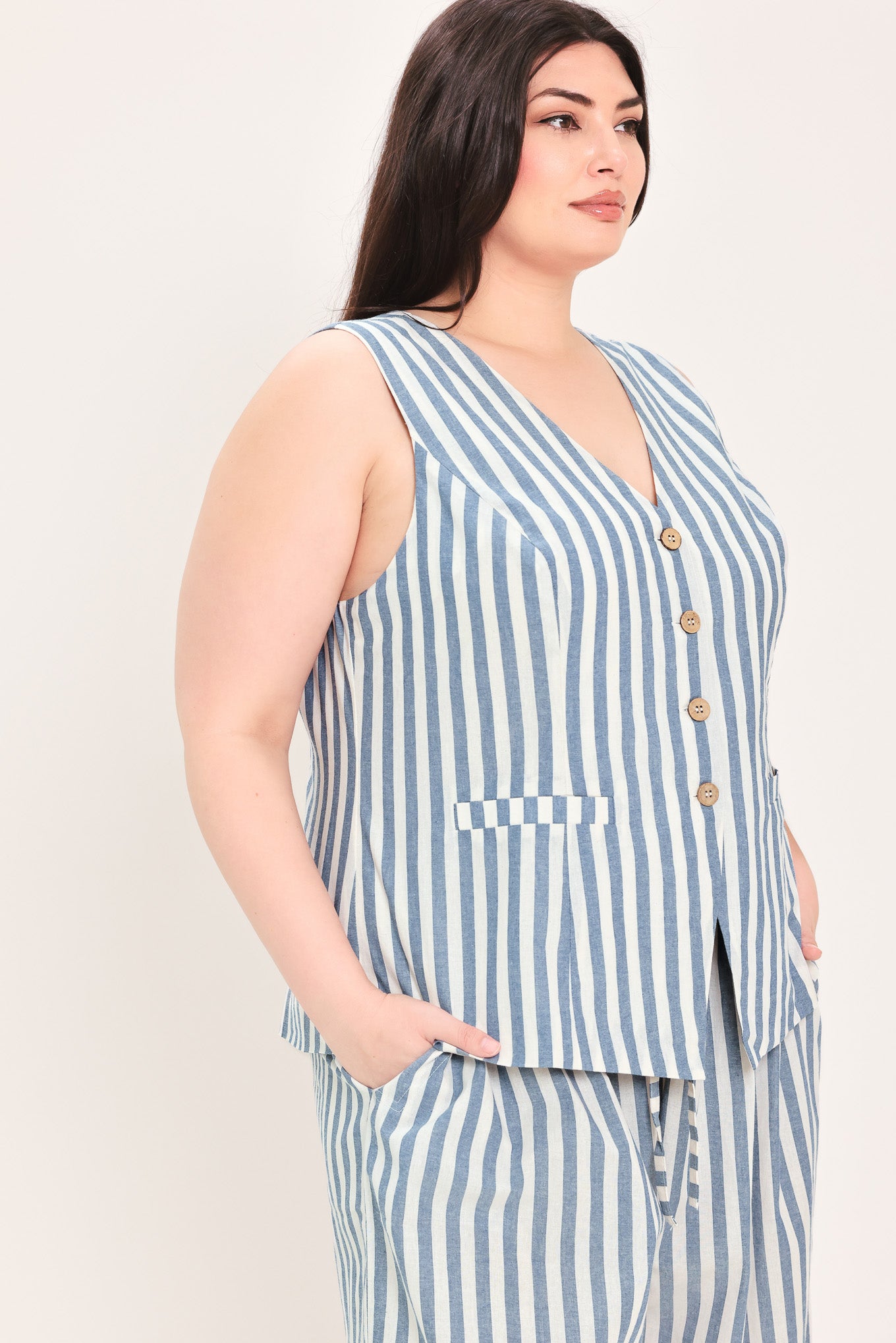 Woman wearing a a striped woven vest with front closure and sleeveless | FREEMARKET