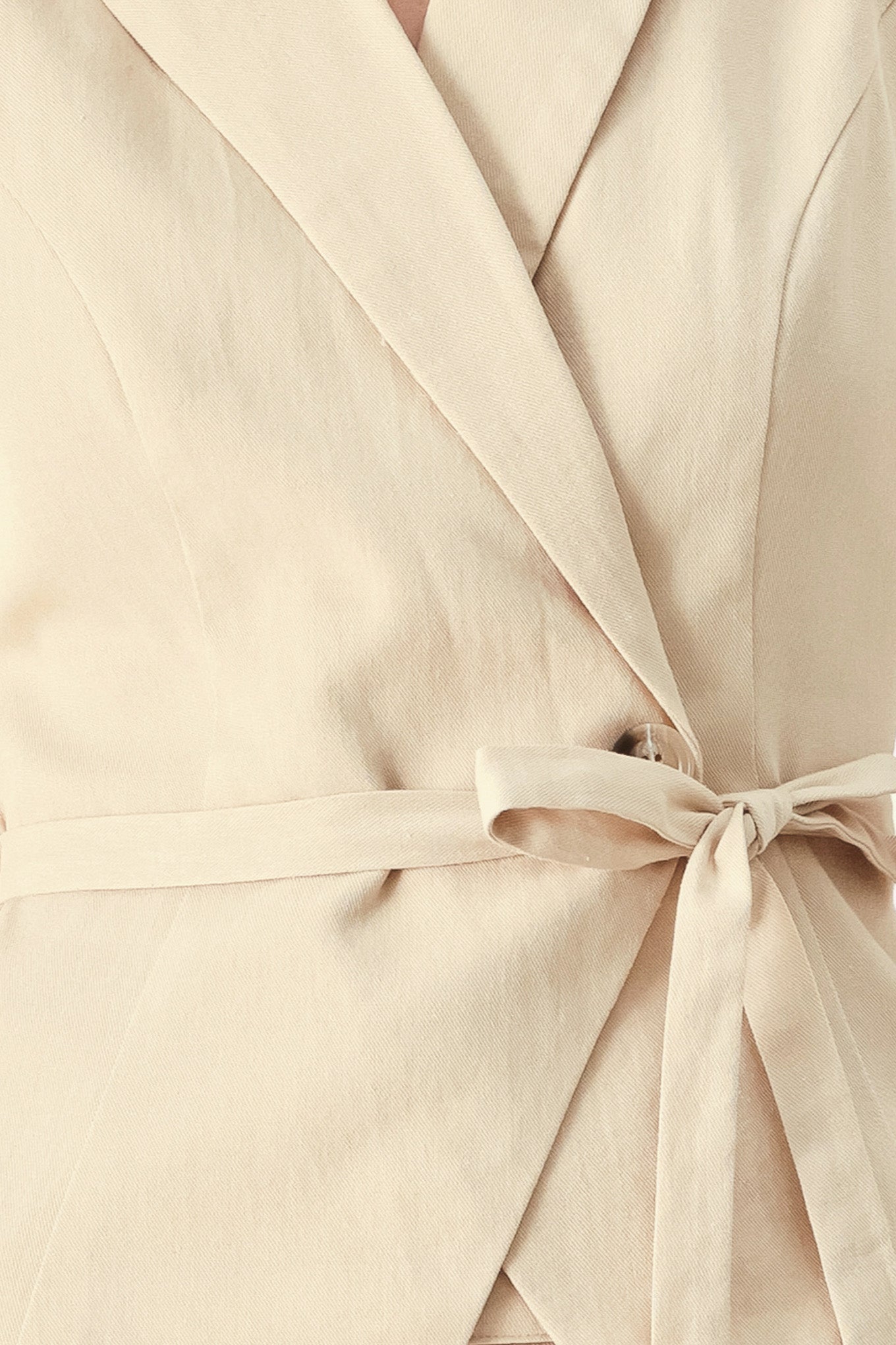 Close up of a light tan woven vest with collar, cap sleeve and button closure | FREEMARKET