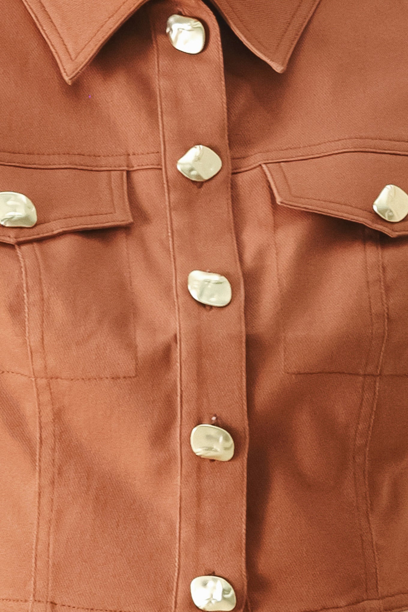 Close-up of a rust-colored crop top with gold buttons | FREEMARKET | Flying Tomato