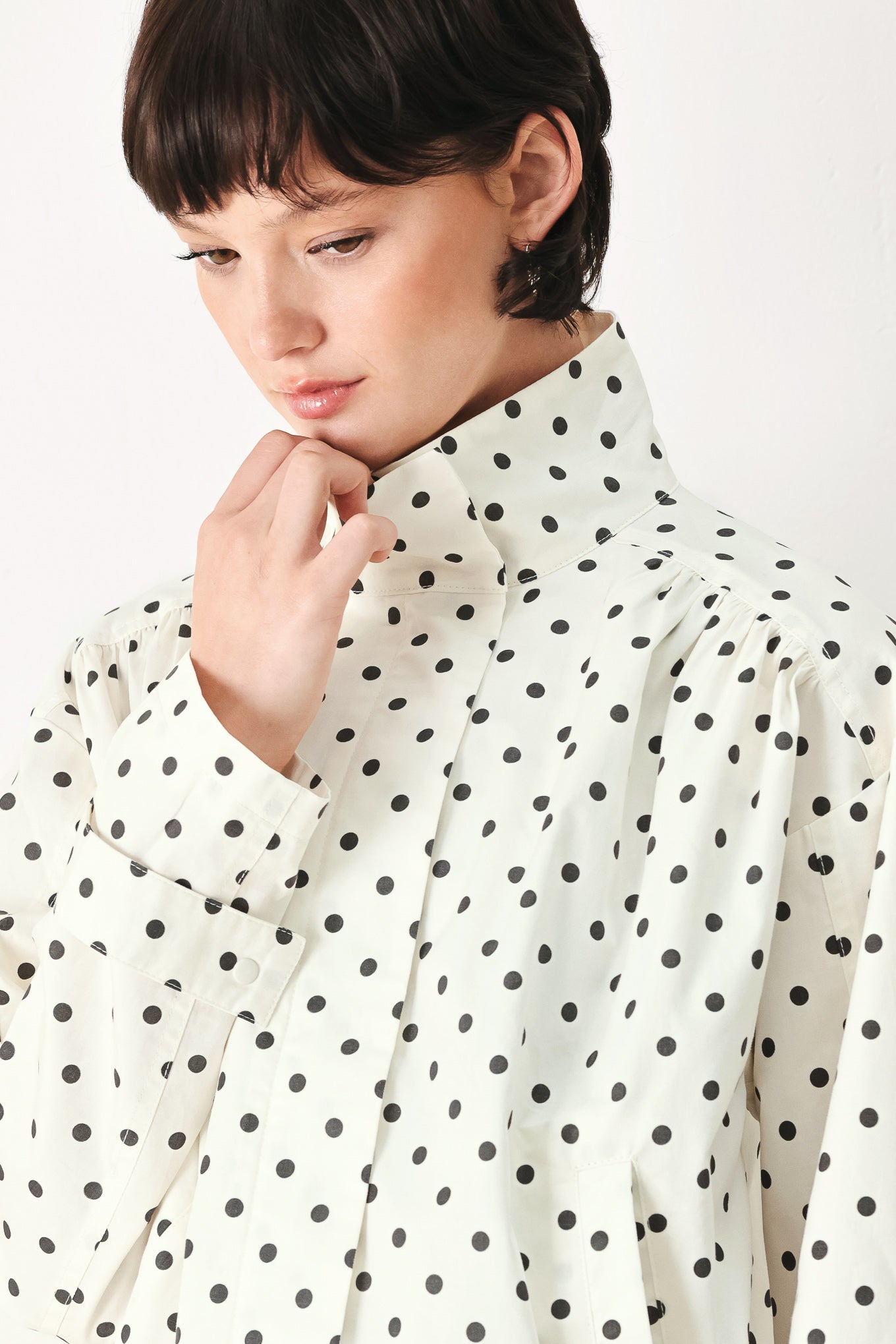 Woman wearing a polka dot jacket featuring funnel neck, long sleeve and front closure with waist tie | FREEMARKET