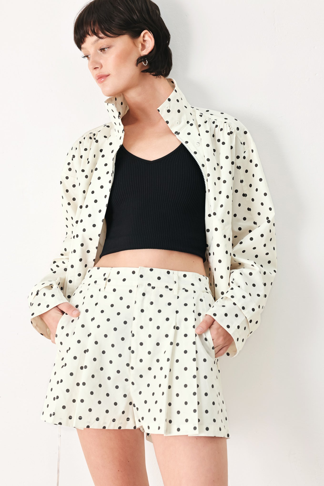 Woman wearing a polka dot jacket featuring funnel neck, long sleeve and front closure with waist tie | FREEMARKET
