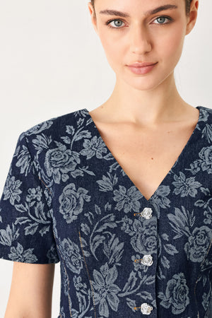 Woman wearing a denim woven jacquard top with V neckline, short sleeve, front button down and peplum | FREEMARKET