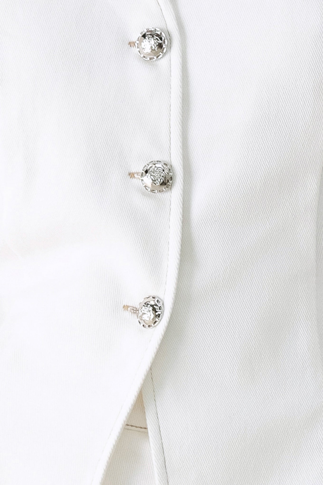Close-up of a white vest with crystal buttons | FREEMARKET