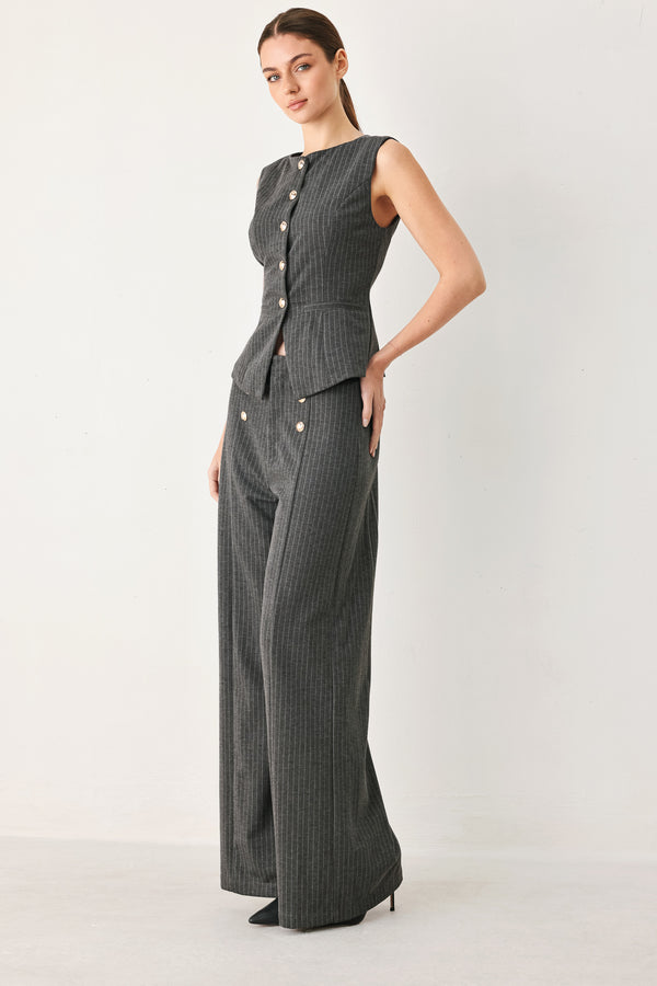 Woman wearing a charcoal and white striped stretch woven vest with wide neckline, sleeveless and front button closure | FREEMARKET