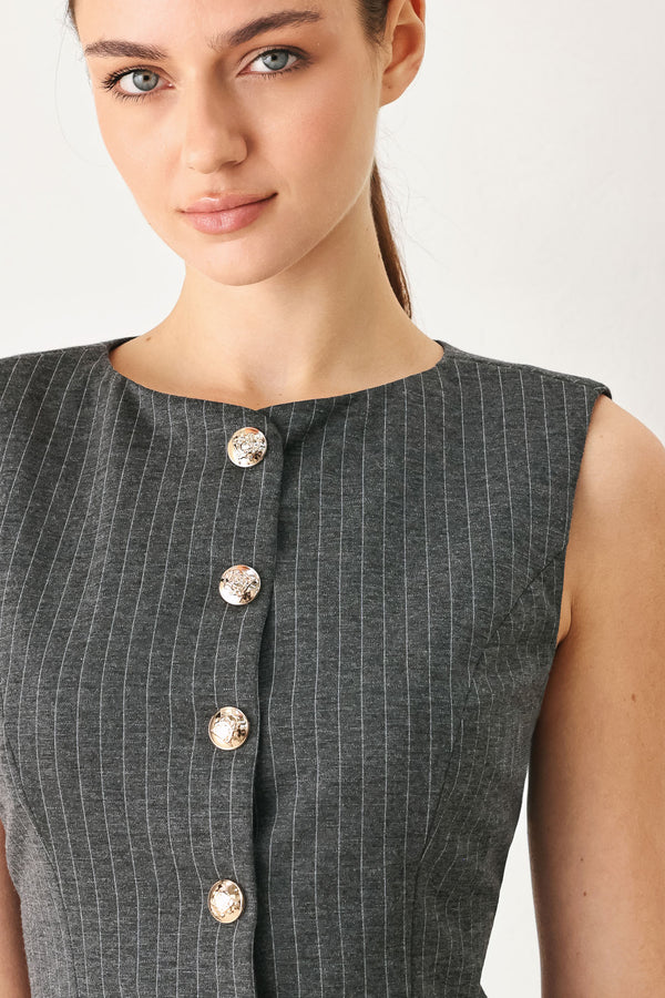 Woman wearing a charcoal and white striped stretch woven vest with wide neckline, sleeveless and front button closure | FREEMARKET