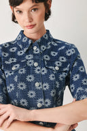 Woman wearing a blue denim floral patterned jacquard crop jacket featuring collar, elbow sleeve and front button closure | FREEMARKET