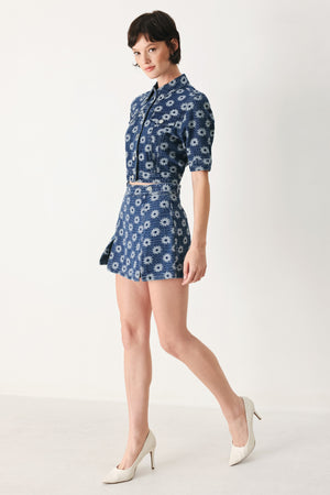 Woman wearing a blue denim floral patterned jacquard crop jacket featuring collar, elbow sleeve and front button closure | FREEMARKET