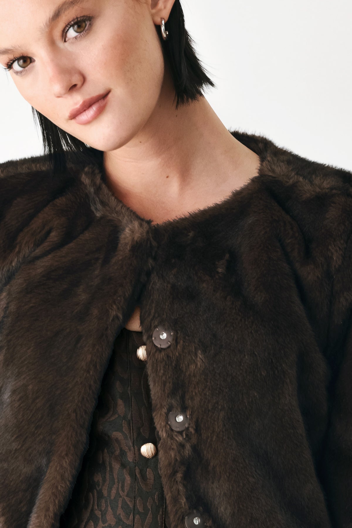 A model wearing a dark brown faux fur cropped jacket | FREEMARKET